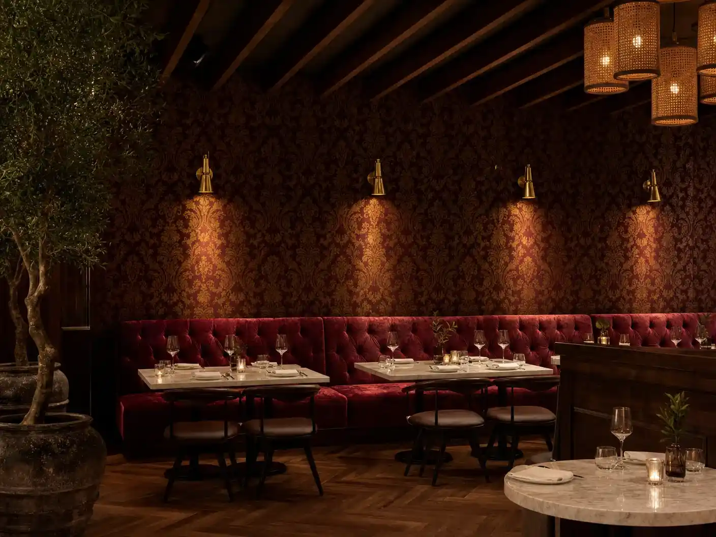 Dallas restaurant with oxblood damask wallpaper above velvet banquette